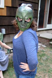 Woman wearing a reptile mask.