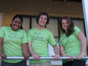 Three students in matching lime green shirts.