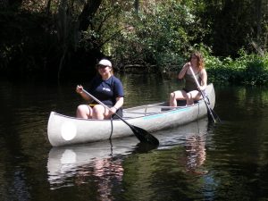 Two students paddling.