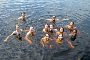 13 students in the water for a photo
