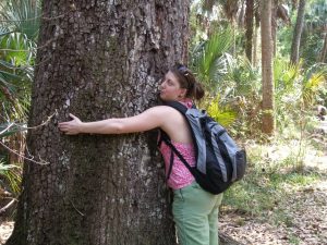 Student hugging a tree.